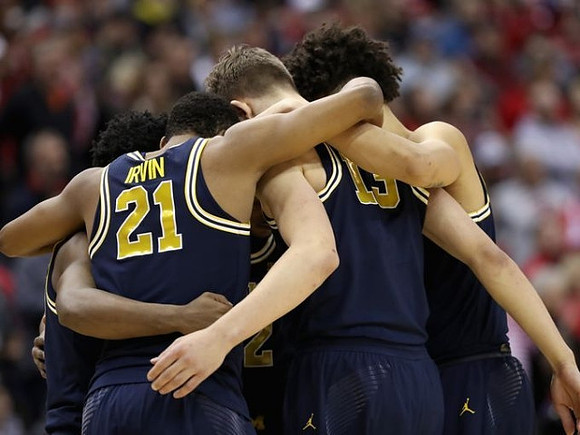 Zak Irvin (21), Moritz Wagner (13), D.J. Wilson (5), Derrick Walton Jr. (10), and Muhammad-Ali Abdur-Rahkman (12)