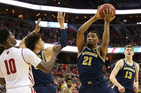 D.J. Wilson (5), Zak Irvin (21), and Moritz Wagner (13)