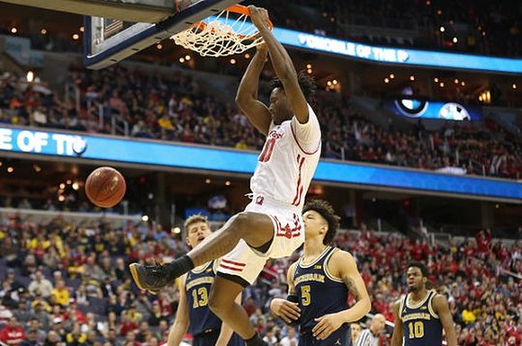 Muhammad-Ali Abdur-Rahkman (12), D.J. Wilson (5), and Derrick Walton Jr. (10)