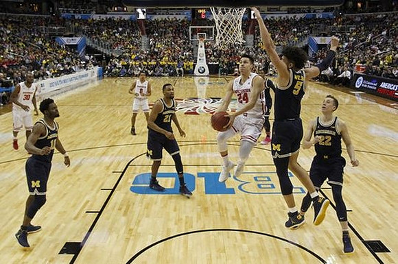 Derrick Walton Jr. (10), Zak Irvin (21), Muhammad-Ali Abdur-Rahkman (12), D.J. Wilson (5), and Duncan Robinson (22)