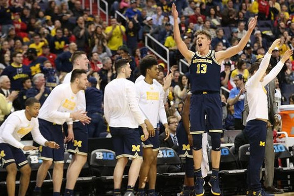 Moritz Wagner (13) and Michigan Team
