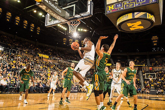 Duncan Robinson (22), Caris LeVert (23), and Mark Donnal (34)