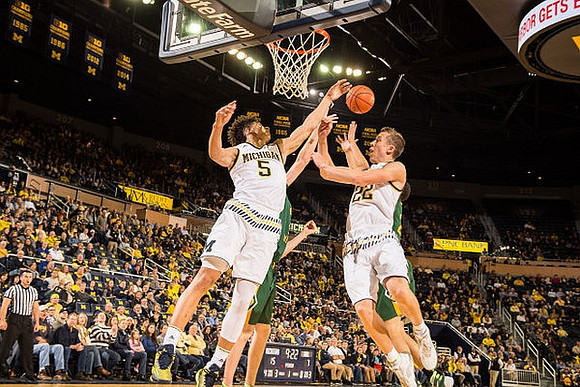 D.J. Wilson (5) and Duncan Robinson (22)