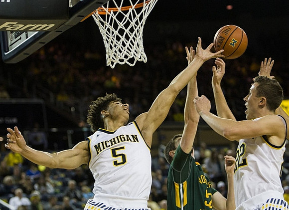 D.J. Wilson (5) and Duncan Robinson (22)