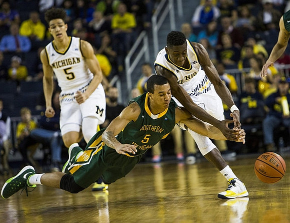 D.J. Wilson (5) and Caris LeVert (23)
