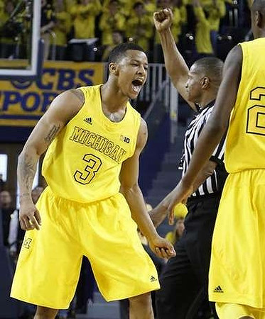 Trey Burke (3) and Caris LeVert (23)