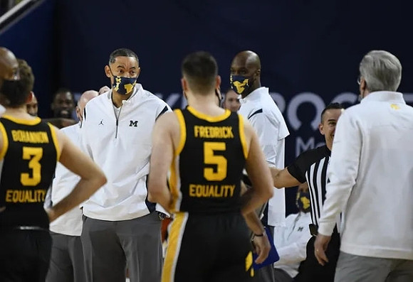 Juwan Howard, Chris Hunter, and Iowa Head Coach Fran McCaffery