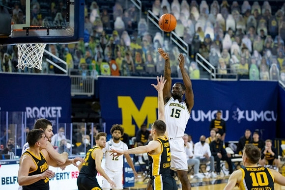 Hunter Dickinson (1), Mike Smith (12), and Chaundee Brown Jr. (15)