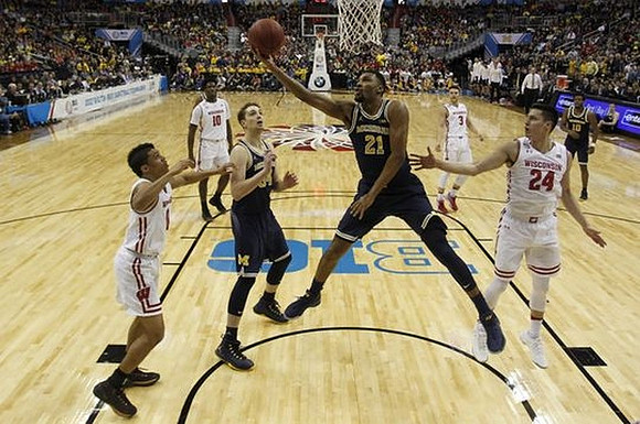 Mark Donnal (34), Zak Irvin (21), and Derrick Walton Jr. (10)
