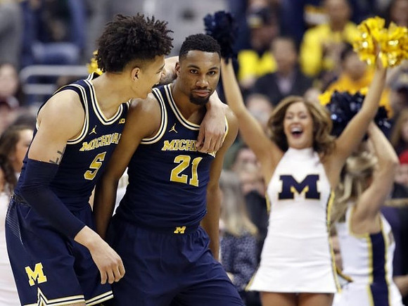 D.J. Wilson (5) and Zak Irvin (21)