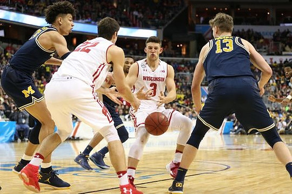 D.J. Wilson (5), Zak Irvin (21), and Moritz Wagner (13)