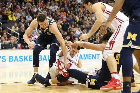 Duncan Robinson (22) and D.J. Wilson (5)