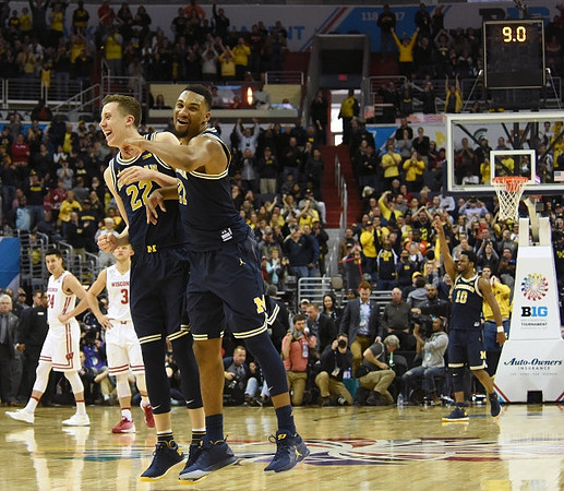 Duncan Robinson (22), Zak Irvin (21), and Derrick Walton Jr. (10)