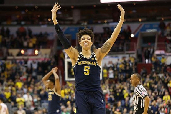 D.J. Wilson (5) and Zak Irvin (21)