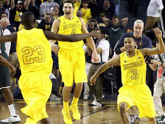 Caris LeVert (23), Mitch McGary (4), and Trey Burke (3)