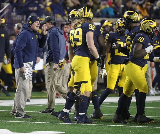 Don Brown, Noah Furbush (59), Kwity Paye (19), David Long (22), Aubrey Solomon (5), and Devin Bush (10)