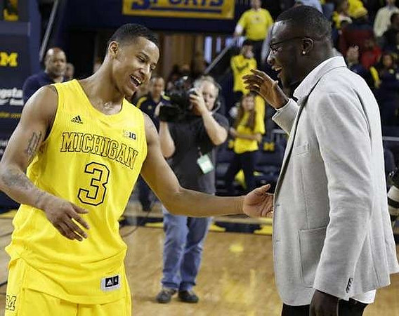 Trey Burke (3) and Devin Gardner