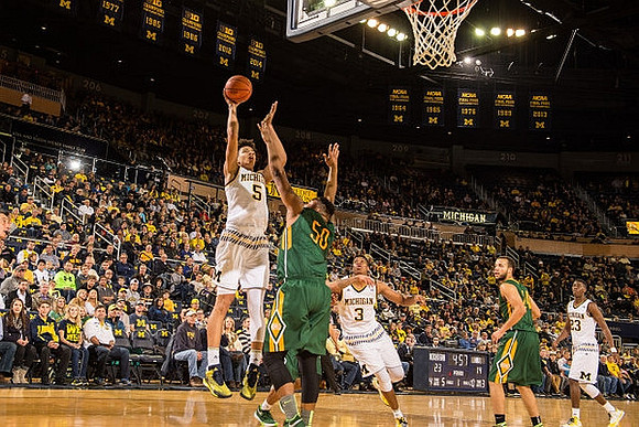 D.J. Wilson (5), Kameron Chatman (3), and Caris LeVert (23)