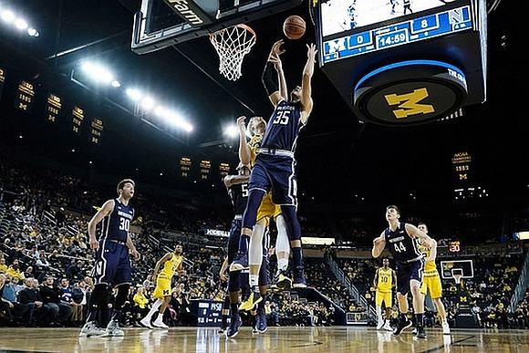 Zak Irvin (21), Mark Donnal (34), Derrick Walton Jr. (10), and Duncan Robinson (22)