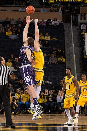 Mark Donnal (34), Derrick Walton Jr. (10), and Muhammad-Ali Abdur-Rahkman (12)