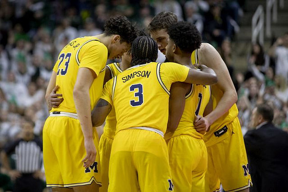 Brandon Johns Jr. (23), Zavier Simpson (3), David DeJulius (0), and Franz Wagner (21)