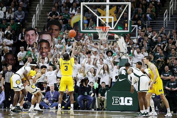 Brandon Johns Jr. (23), Zavier Simpson (3), and Franz Wagner (21)