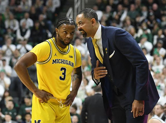 Zavier Simpson (3) and Juwan Howard