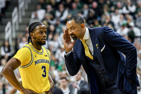Zavier Simpson (3) and Juwan Howard