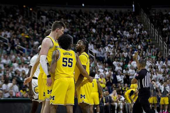 Jon Teske (15), Eli Brooks (55), and Zavier Simpson (3)