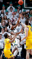 Zavier Simpson (3) and Jon Teske (15)