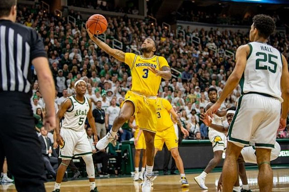 Zavier Simpson (3) and Brandon Johns Jr. (23)