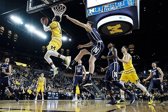 Duncan Robinson (22), Muhammad-Ali Abdur-Rahkman (12), and Mark Donnal (34)