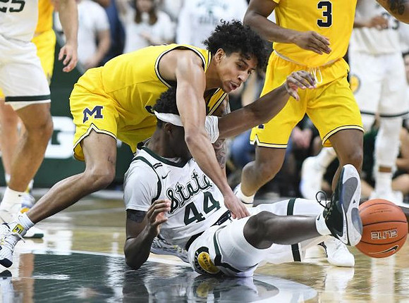 Eli Brooks (55) and Zavier Simpson (3)