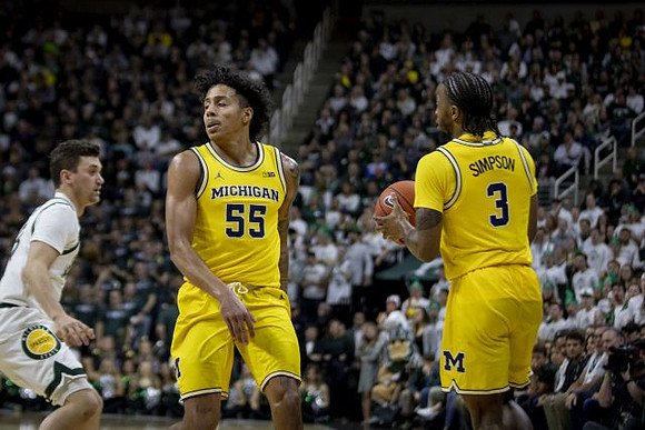 Eli Brooks (55) and Zavier Simpson (3)