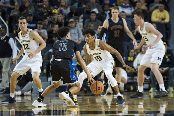 Duncan Robinson (22), Eli Brooks (55), and Jon Teske (15)