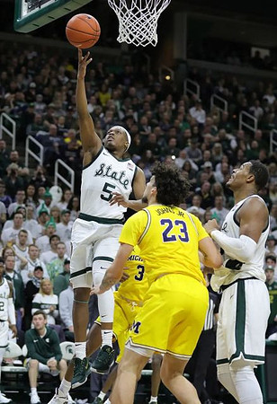 Brandon Johns Jr. (23) and Zavier Simpson (3)