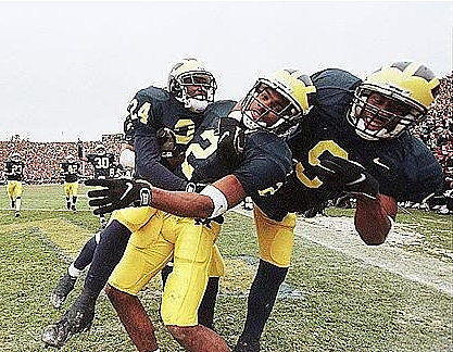 Charles Woodson, Patrick McCall (24), and DiAllo Johnson (9)