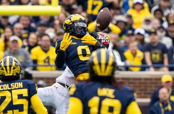 Junior Colson (25), Mike Sainristil (0), and Eyabi Anoma Okie (18)