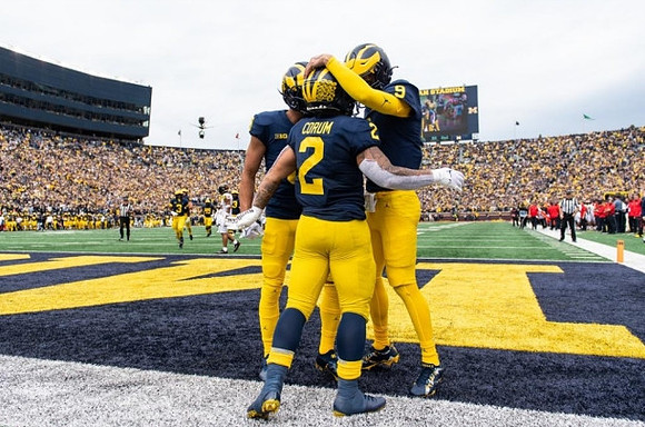 Ronnie Bell (8), Blake Corum (2), and J.J. McCarthy (9)