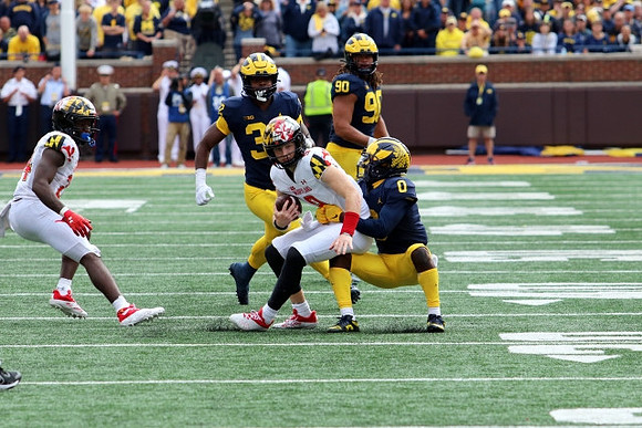 Mike Sainristil (0), Jaylen Harrell (32), and Mike Morris (90)