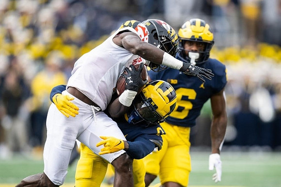 Mike Sainristil (0) and R.J. Moten (6)