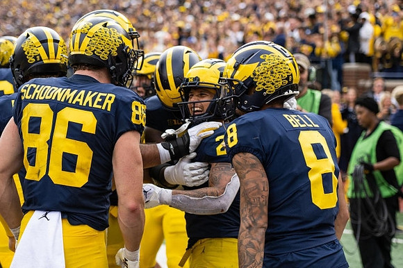 Luke Schoonmaker (86), Blake Corum (2), and Ronnie Bell (8)