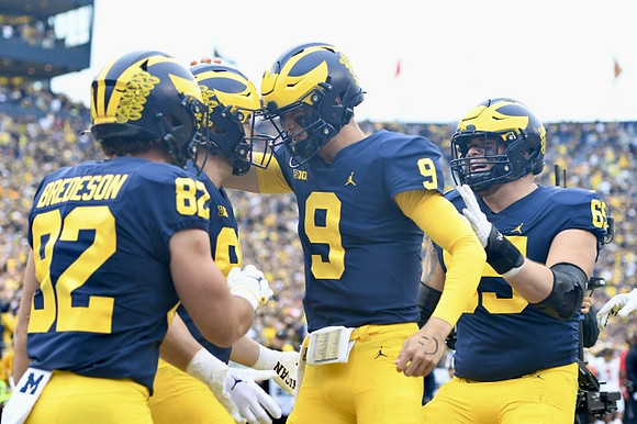 Max Bredeson (82), Luke Schoonmaker (86), J.J. McCarthy (9), and Zak Zinter (65)