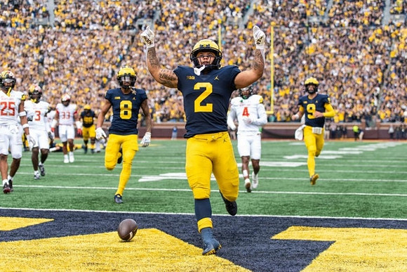 Ronnie Bell (8), Blake Corum (2), and J.J. McCarthy (9)