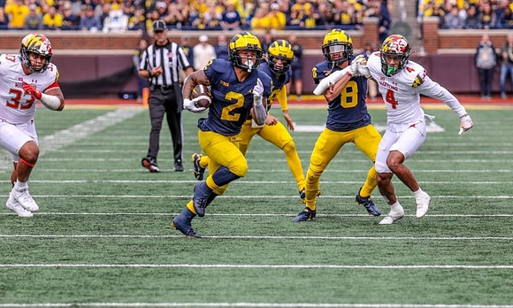 Blake Corum (2), J.J. McCarthy (9), and Ronnie Bell (8)