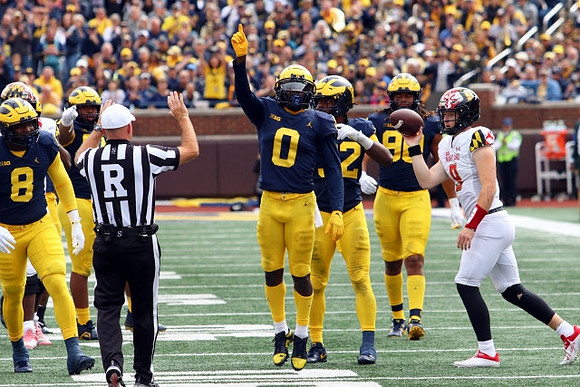 Derrick Moore (8), Mike Sainristil (0), Jaylen Harrell (32), and Mike Morris (90)