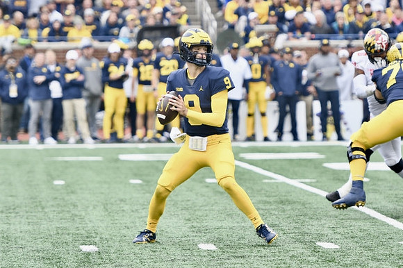 J.J. McCarthy (9) and Ryan Hayes (76)