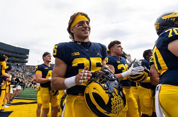 Caden Kolesar (35) and Michigan Team