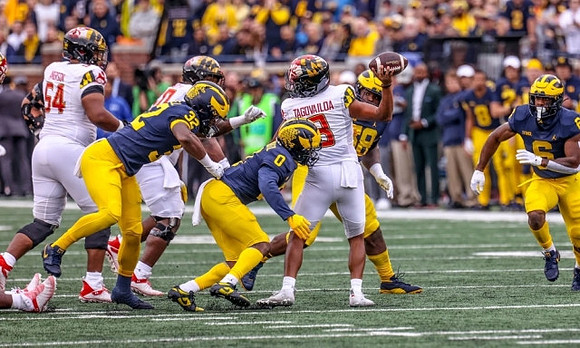 Jaylen Harrell (32), Mike Sainristil (0), Mazi Smith (58), and R.J. Moten (6)
