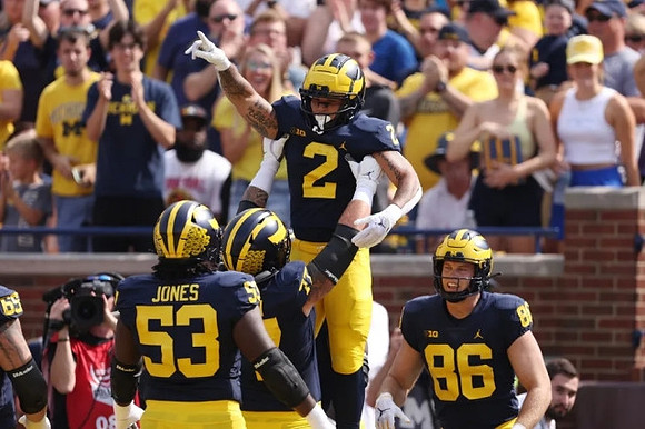 Trente Jones (53), Trevor Keegan (77), Blake Corum (2), and Luke Schoonmaker (86)